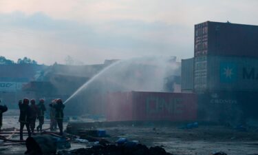 Firefighters work to contain a fire that broke out at the BM Inland Container Depot