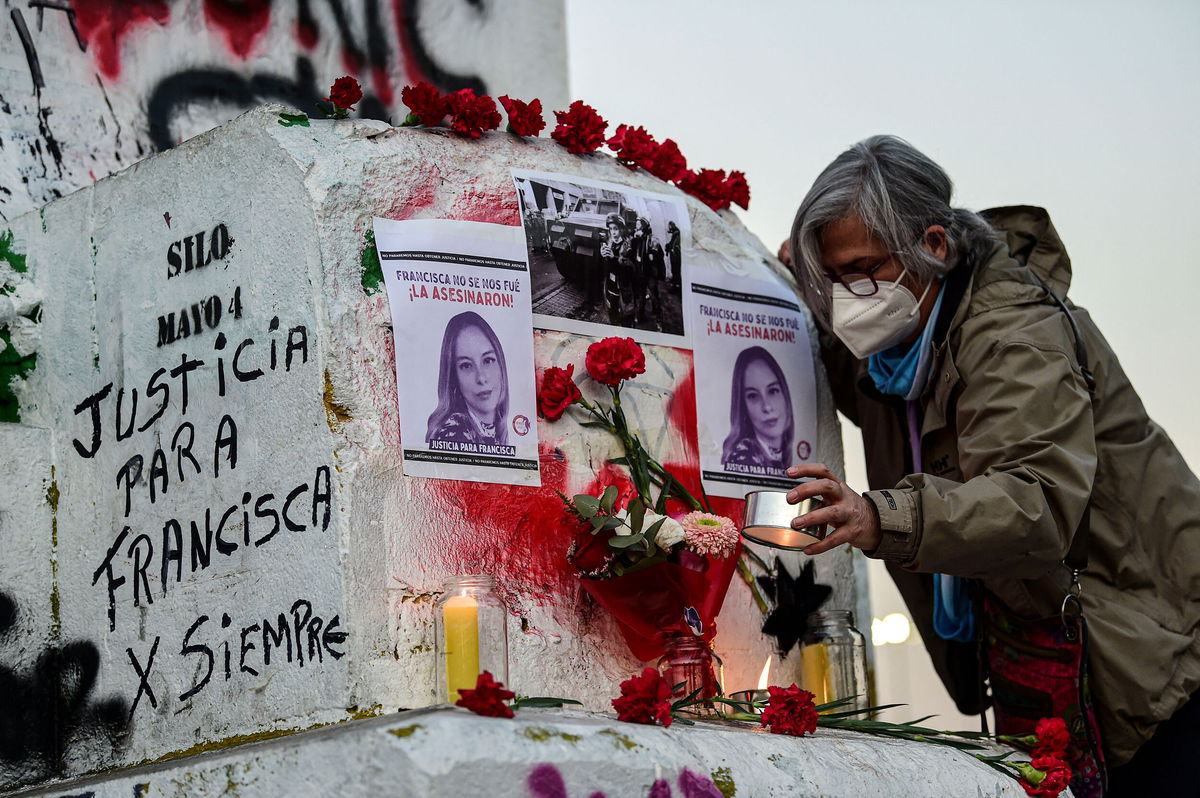 <i>Martin Bernetti/AFP/Getty Images</i><br/>Chileans call for justice at a vigil for the late journalist Francisca Sandoval in Santiago on May 13.