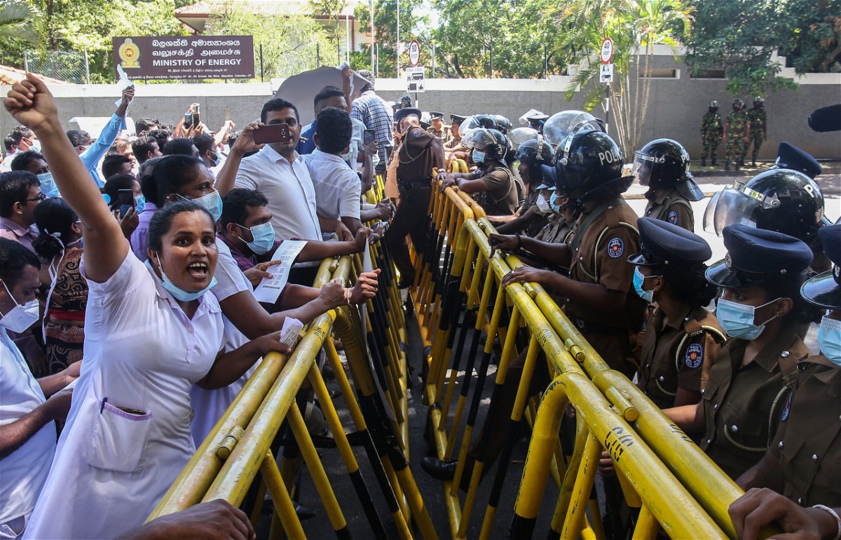 <i>Pradeep Dambarage/NurPhoto/Reuters</i><br/>Sri Lankan health workers protest amid the country's economic crisis in Colombo on June 29.