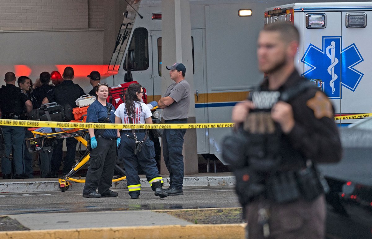 <i>Kelly Wilkinson/AP</i><br/>Emergency personnel gather after a deadly shooting Sunday