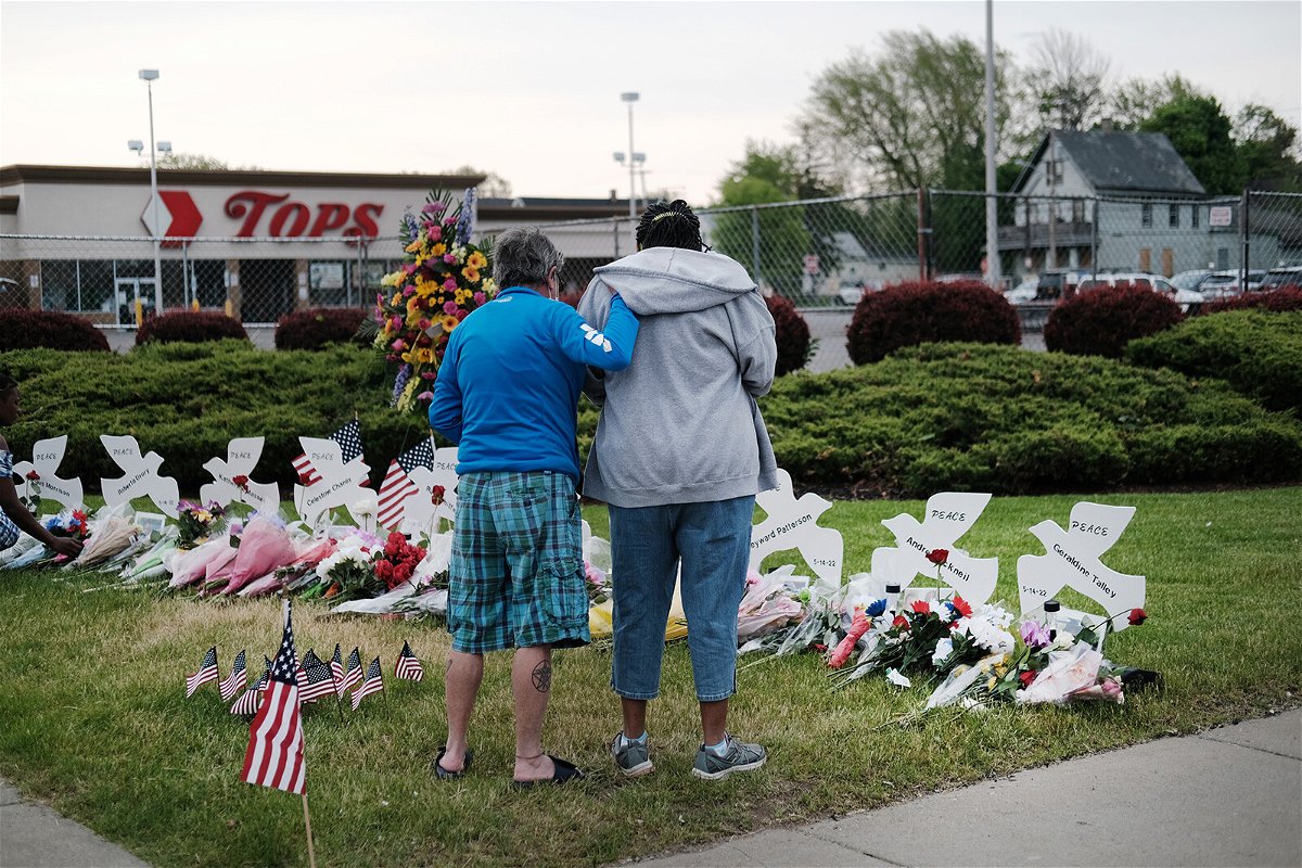 <i>Spencer Platt/Getty Images</i><br/>People gather at a memorial for the shooting victims outside of Tops market in Buffalo