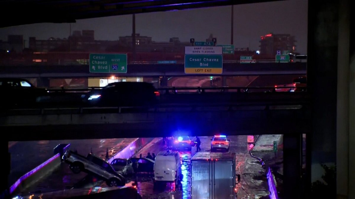 <i>KTVT</i><br/>Multiple cars are pictured submerged in waters from flash flooding in the early morning hours of August 22 in Dallas.