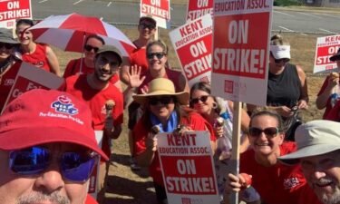 Members of the Kent Education Association strike to begin the school year.