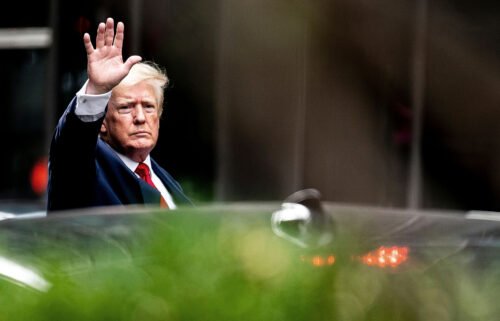 Former President Donald Trump waves as he departs Trump Tower on August 10 in New York City. A federal appeals court ruled that the DOJ must make a public memo analyzing whether to charge Trump in the Russia investigation.
