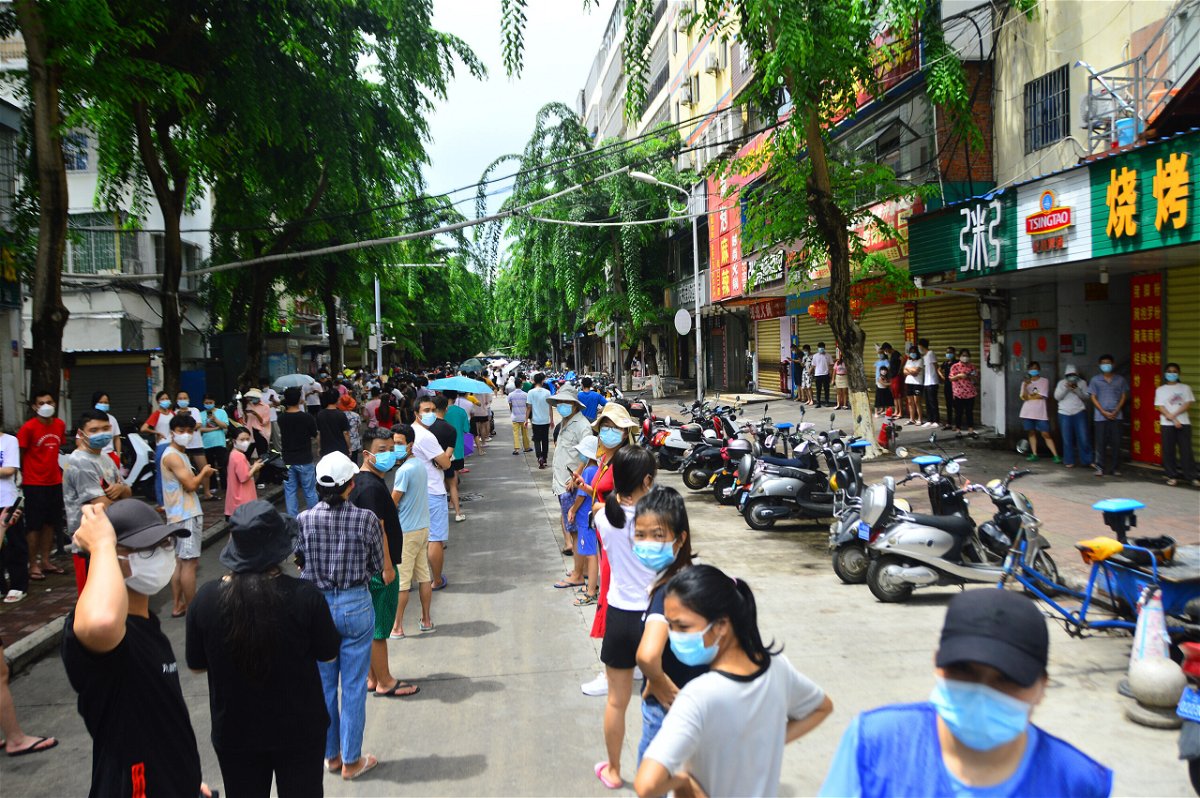<i>VCG/Getty Images</i><br/>People line up for nucleic acid testing in Sanya