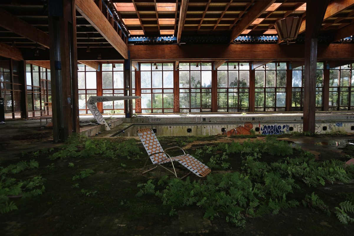 <i>John Moore/Getty Images</i><br/>A lawn chair sits as nature takes over the indoor pool area of Grossinger's Catskill Resort Hotel on July 5