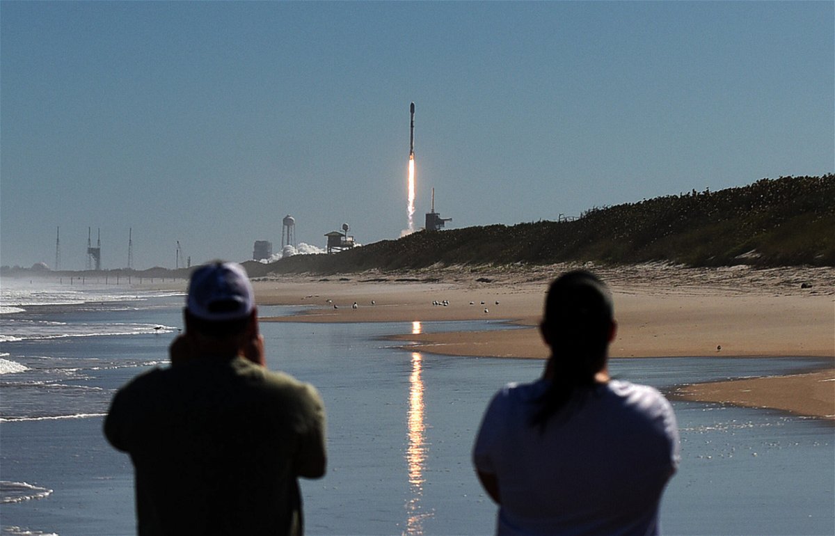 <i>Paul Hennessy/SOPA Images/LightRocket/Getty images</i><br/>People watch from Canaveral National Seashore as a SpaceX Falcon 9 rocket launches from pad 39A at the Kennedy Space Center in Cape Canaveral