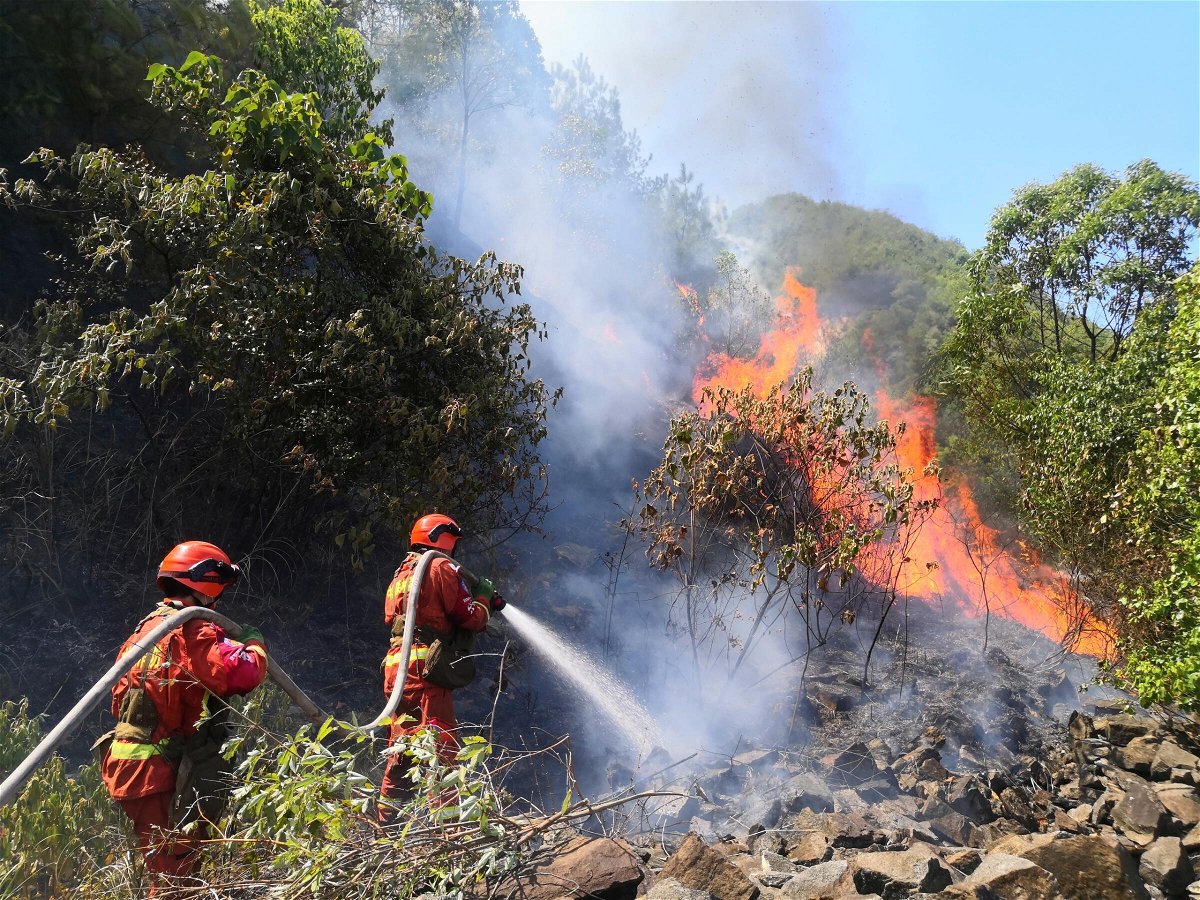 <i>VCG/Getty Images</i><br/>Firefighters combat a mountain wildfire in Chongqing