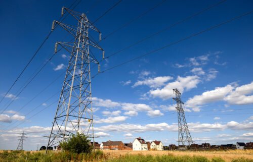 Electricity transmission towers are pictured near a new residential housing estate in Rayleigh