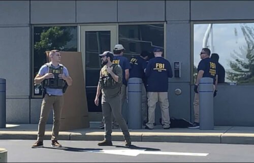 FBI officials gather outside the FBI building in Cincinnati on August 11 after an armed man tried to breach a security screening area leading to an hours-long standoff with law enforcement.