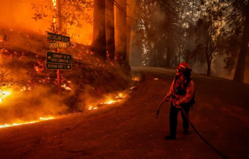 A firefighter monitors flames from the Mosquito Fire in Placer County