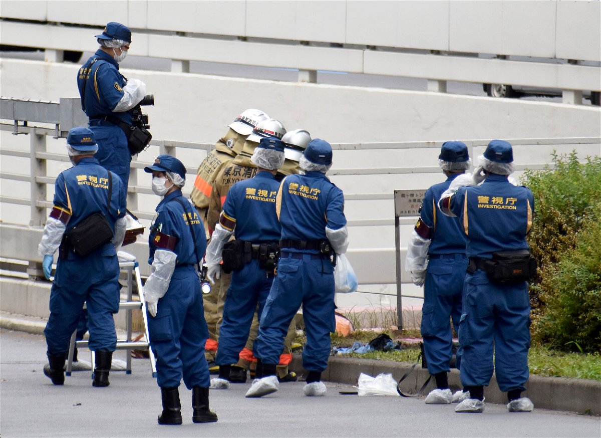 <i>Kyodo News/AP</i><br/>Japanese police and firefighters are pictured here at the scene near the prime minister's office in Tokyo where a man reportedly set himself on fire on September 21.