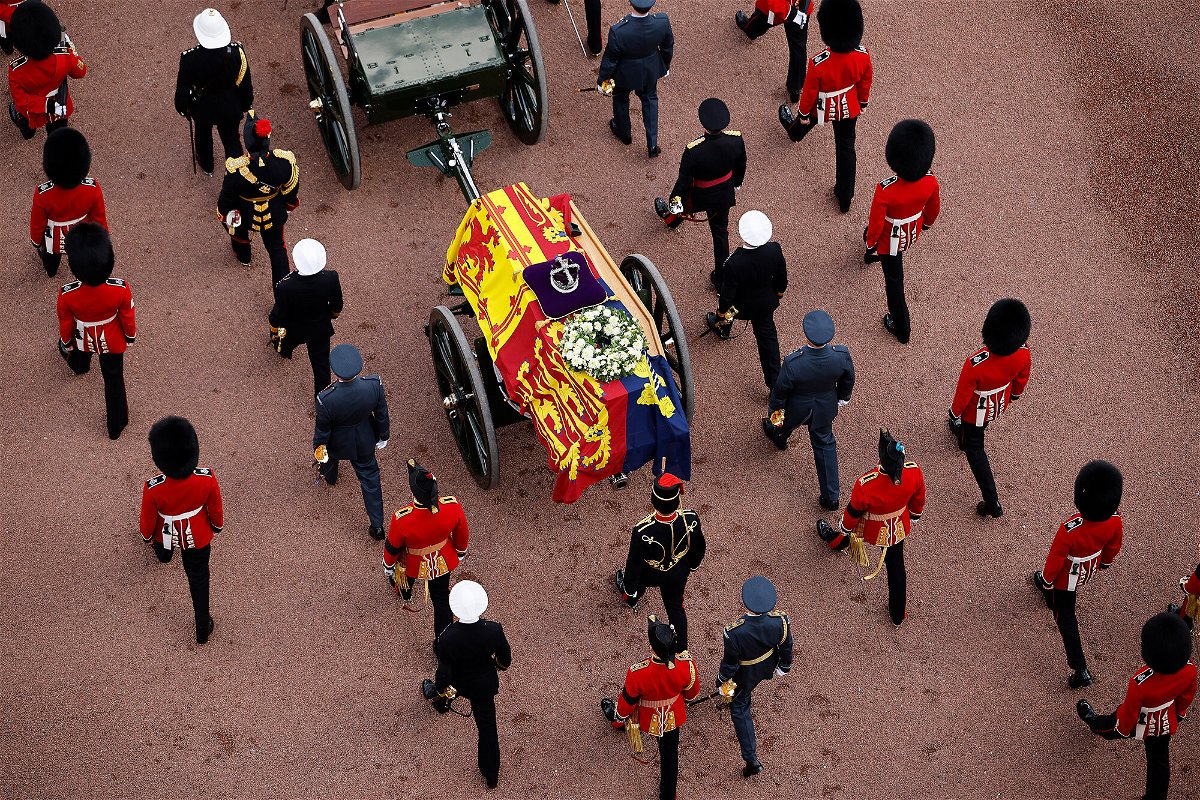 <i>Chip Somodevilla/Getty Images</i><br/>Queen Elizabeth II's flag-draped coffin is taken in procession on a gun garriage of The King's Troop Royal Horse Artillery from Buckingham Palace to Westminster Hall on September 14