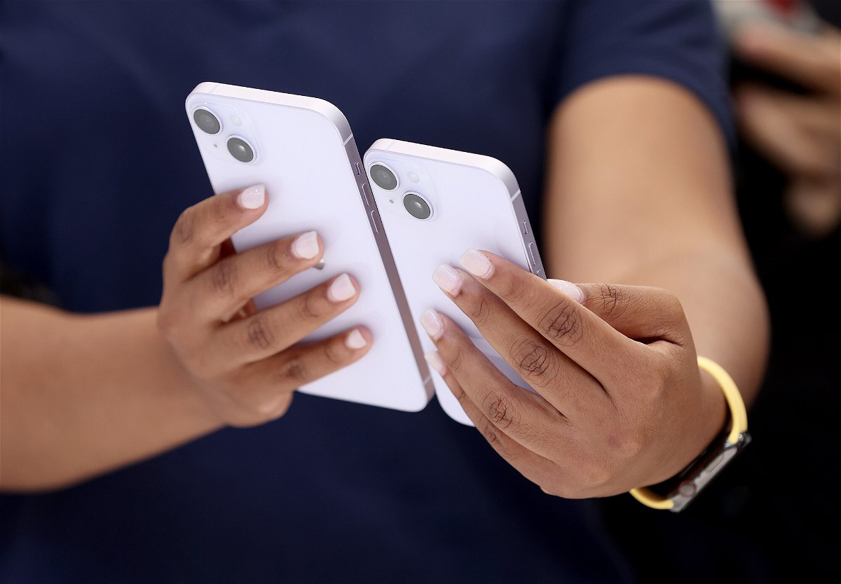 <i>Justin Sullivan/Getty Images</i><br/>Shares of Apple fell 4% in early trading September 28 amid concerns about demand for the company's latest lineup of iPhones. An Apple employee is seen here holding a new iPhone 14 and iPhone 14 Plus during an Apple special event on September 07.