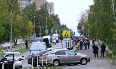 Police and emergency service workers are pictured here near the scene of the school shooting in Izhevsk