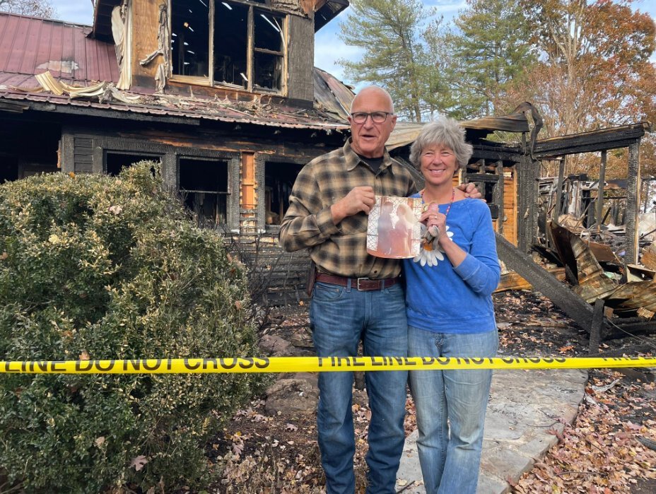 <i>WLOS</i><br/>The Farm owners Beverly (right) and Myron Gottfried found one of their wedding photos while looking through the remains of their property after a Saturday fire.
