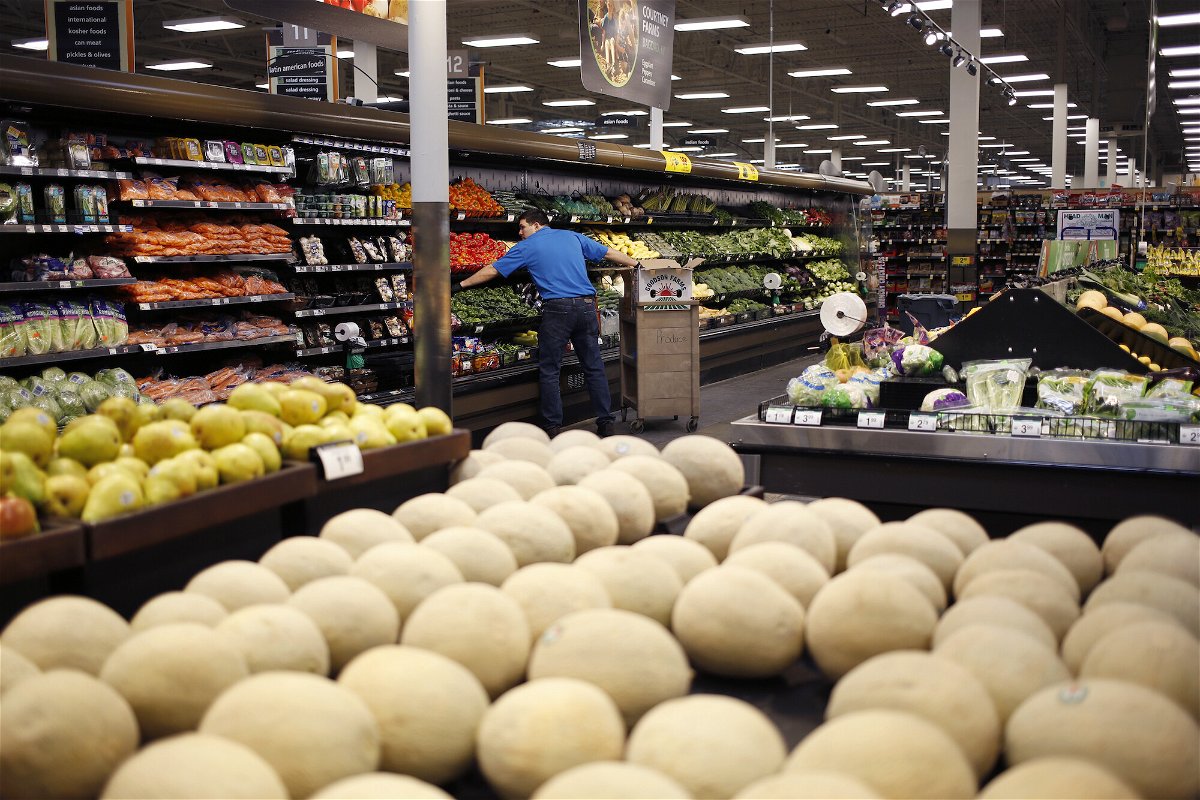 <i>Luke Sharrett/Bloomberg/Getty Images</i><br/>An employee restocks vegetables at a Kroger Co. supermarket in Louisville
