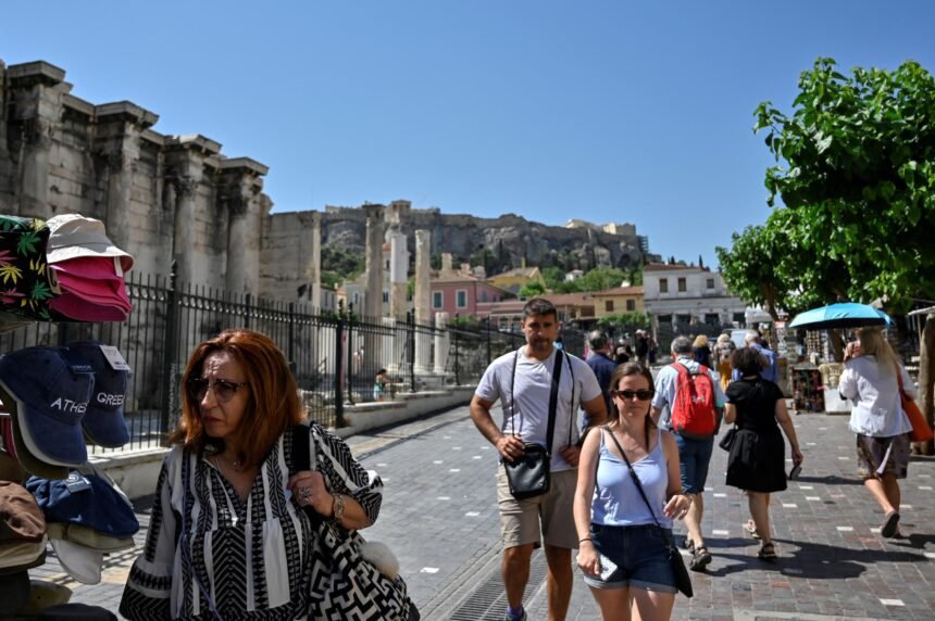 Tourists and locals walk in a touristic area of Athens on June 1. The CDC will no longer maintain a country-by-country list of travel advisories related to Covid-19.