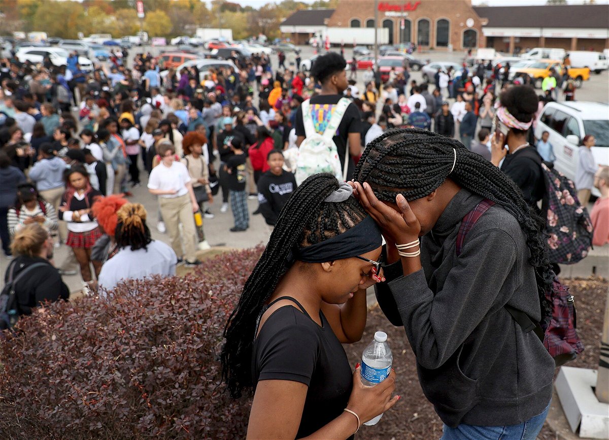 <i>David Carson/AP</i><br/>Students stand in a parking lot near the Central Visual & Performing Arts High School after the shooting.