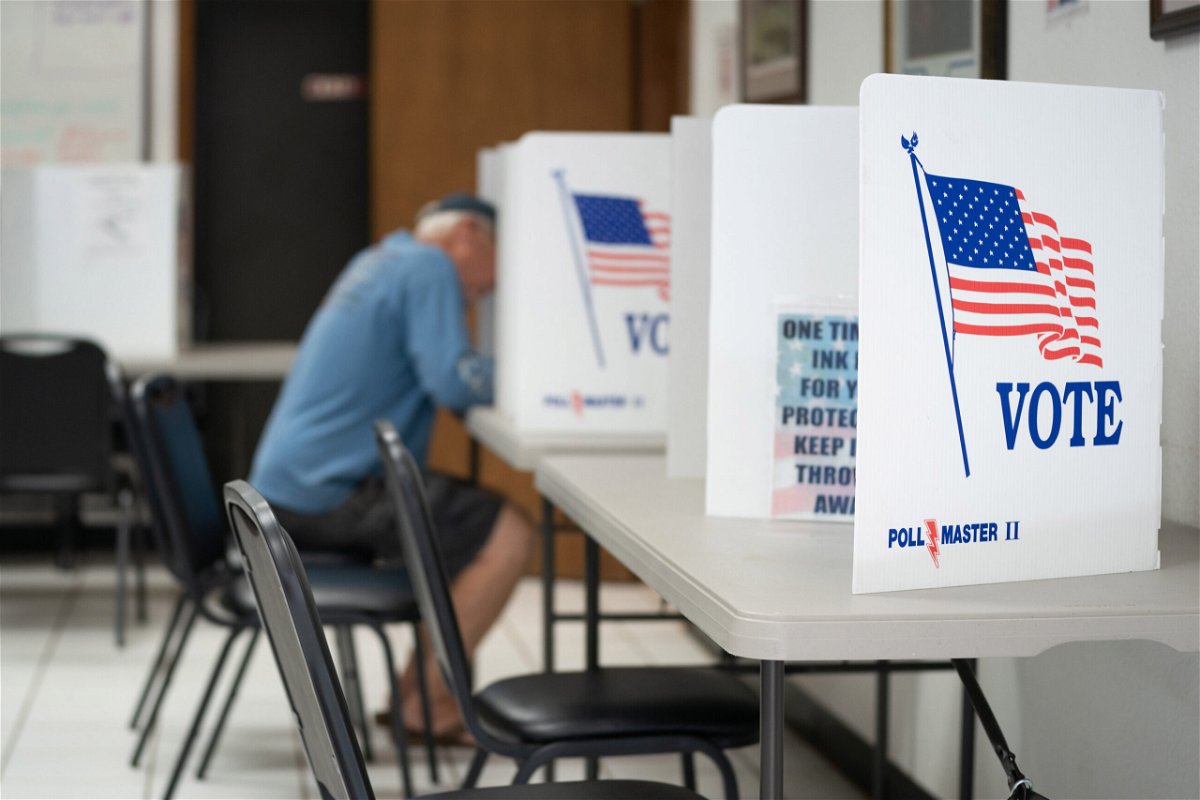 <i>Sean Rayford/Getty Images</i><br/>North Carolina in-person early voting kicks off Thursday. A man here fills out a ballot at a voting booth on May 17