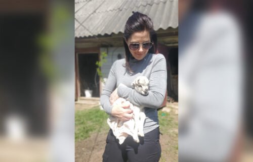 CNN's Erin Burnett holds a newborn goat in the Ukrainian town of Andriivka on May 11.