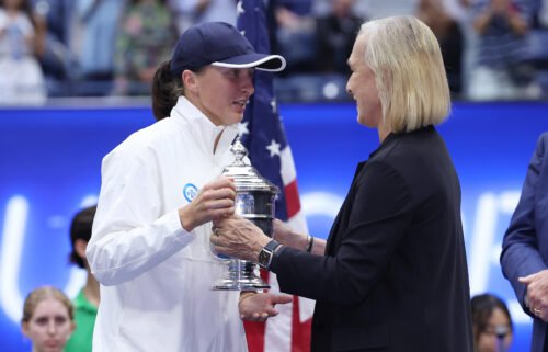 Martina Navratilova (right) presents Iga Swiatek with the US Open trophy.