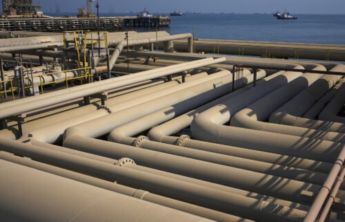 Oil pipelines sit on the quayside beside the Arabian Sea in Saudi Aramco's Ras Tanura oil refinery and oil terminal in Ras Tanura