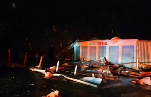 The roof of a commercial structure was blown off and struck a house in Sumiton