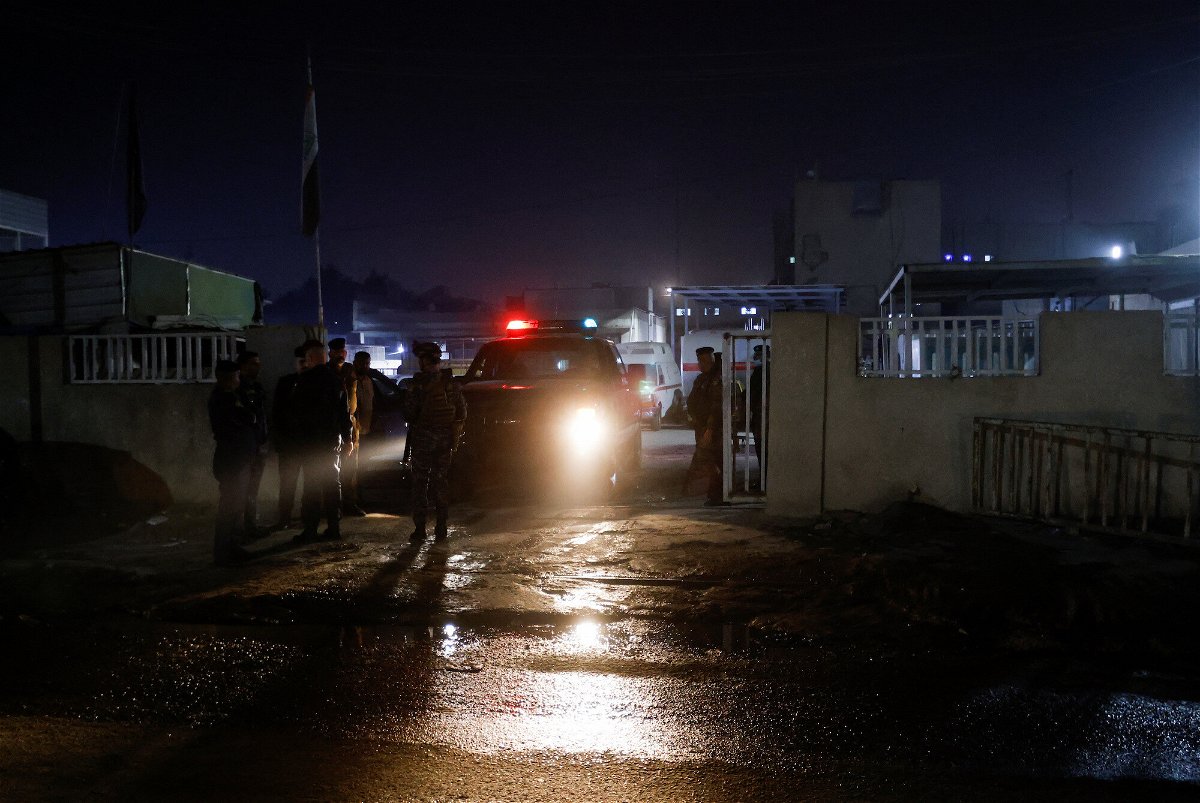 <i>Ahmed Saad/Reuters</i><br/>Iraqi security forces stand guard on November 7 outside the hospital where the body of a U.S. citizen who was killed in Baghdad is being held.