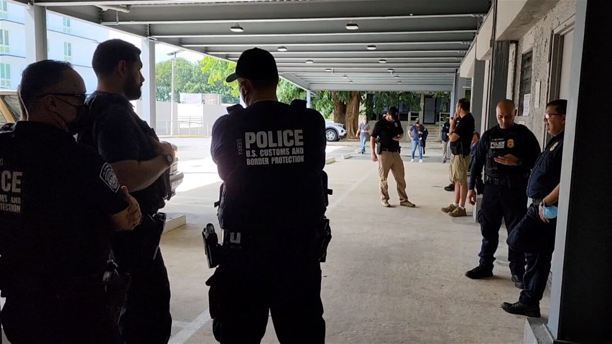 <i>CNNE</i><br/>US Customs and Border Patrol agents stand outside Centro Médico de Río Piedras where injured agents were taken following a shootout on November 17 off the coast of Puerto Rico.