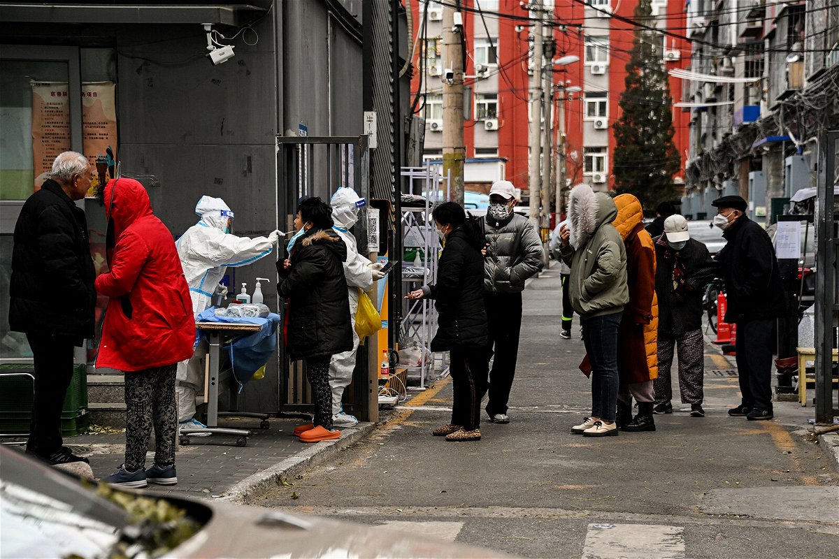 <i>Noel Celis/AFP/Getty Images</i><br/>Residents undergo swab testing at a residential area under lockdown due to Covid-19 restrictions in Beijing on November 29.