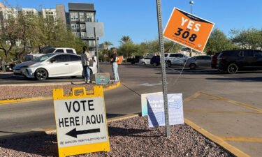 Signs to vote "Yes on 308" are seen during the 2022 US midterm elections at the Burton Barr Library in Phoenix. Arizona voters narrowly passed Proposition 308