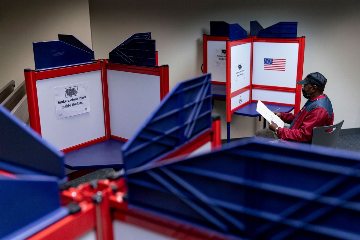 <i>Andrew Harnik/AP</i><br/>Cornelius Whiting fills out his ballot at an early voting location in Alexandria