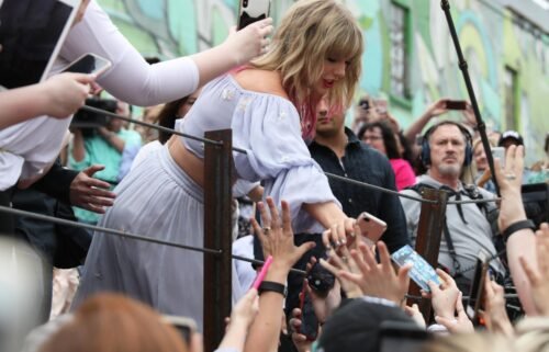 More than two dozen Taylor Swift fans are suing Ticketmaster for "unlawful conduct." Taylor Swift here surprises fans at the new Kelsey Montague "What Lifts You Up" Mural on April 25