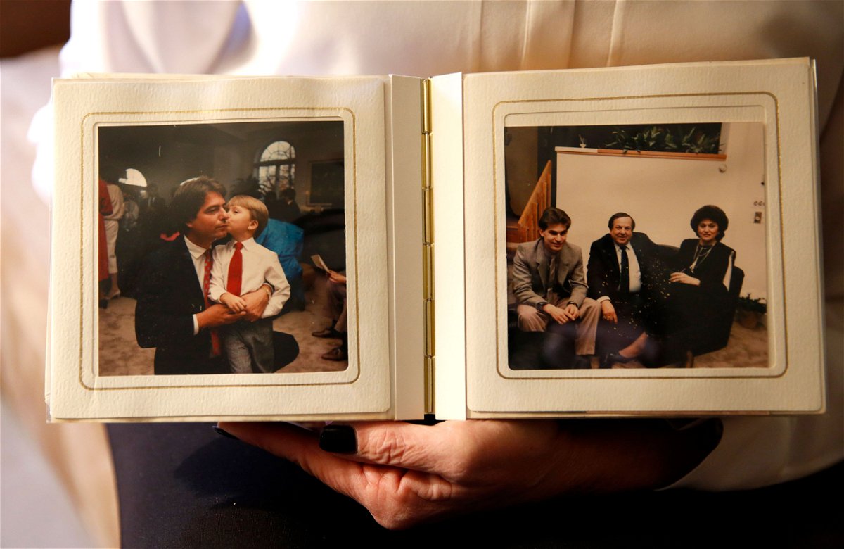 <i>Jessica Rinaldi/The Boston Globe/Getty Images</i><br/>Pamela DiSarro holds a photo album with a photograph of her husband