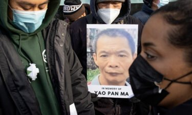 A memorial vigil is held for Yao Pan Ma on the street corner where he was beaten