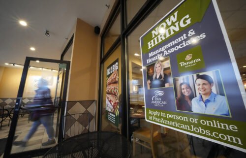 A hiring sign is displayed in the window of a Panera Bread store in Pittsburgh on Monday