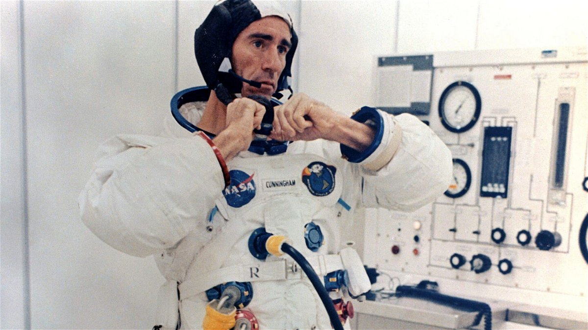<i>NASA</i><br/>Walt Cunningham adjusts his pressure suit before the Apollo 7 launch on October 11