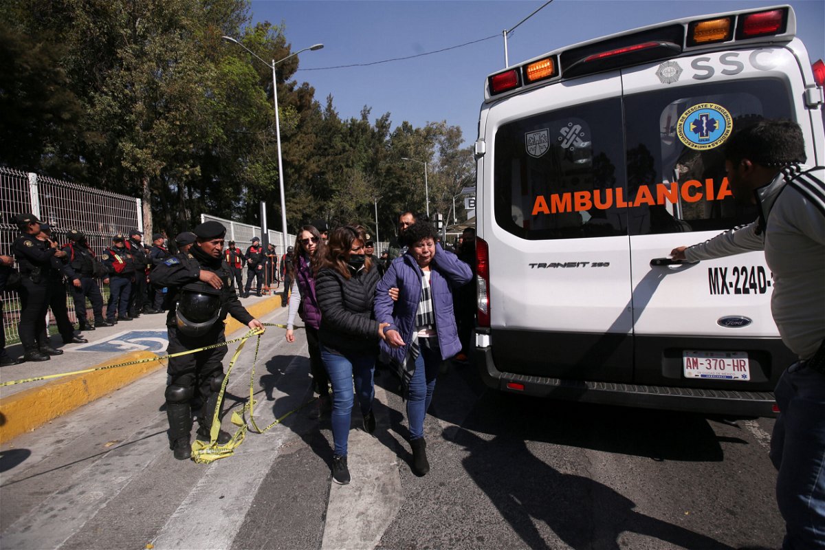 <i>Quetzalli Nicte-Ha/Reuters</i><br/>A woman is helped to reach an ambulance after two subway trains collided at a subway station in Mexico City on January 7.