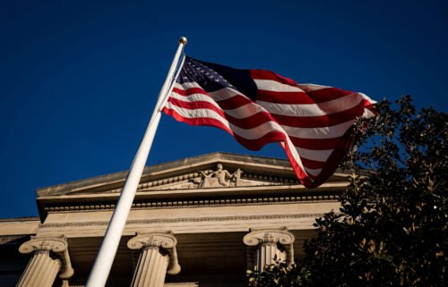 An American flag is seen outside the Department of Justice building in Washington