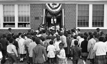 Black schoolchildren entering the Mary E. Branch School at S. Main Street and Griffin Boulevard