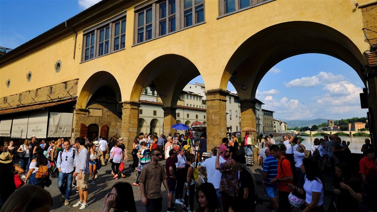 <i>Getty Images</i><br/>People walk on the Ponte Vecchio onto Arno river