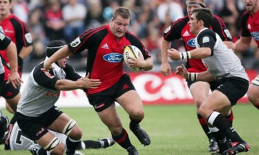 Campbell Johnstone (center) looks to evade a tackle during a match between the Crusaders and the Sharks in February 2006.