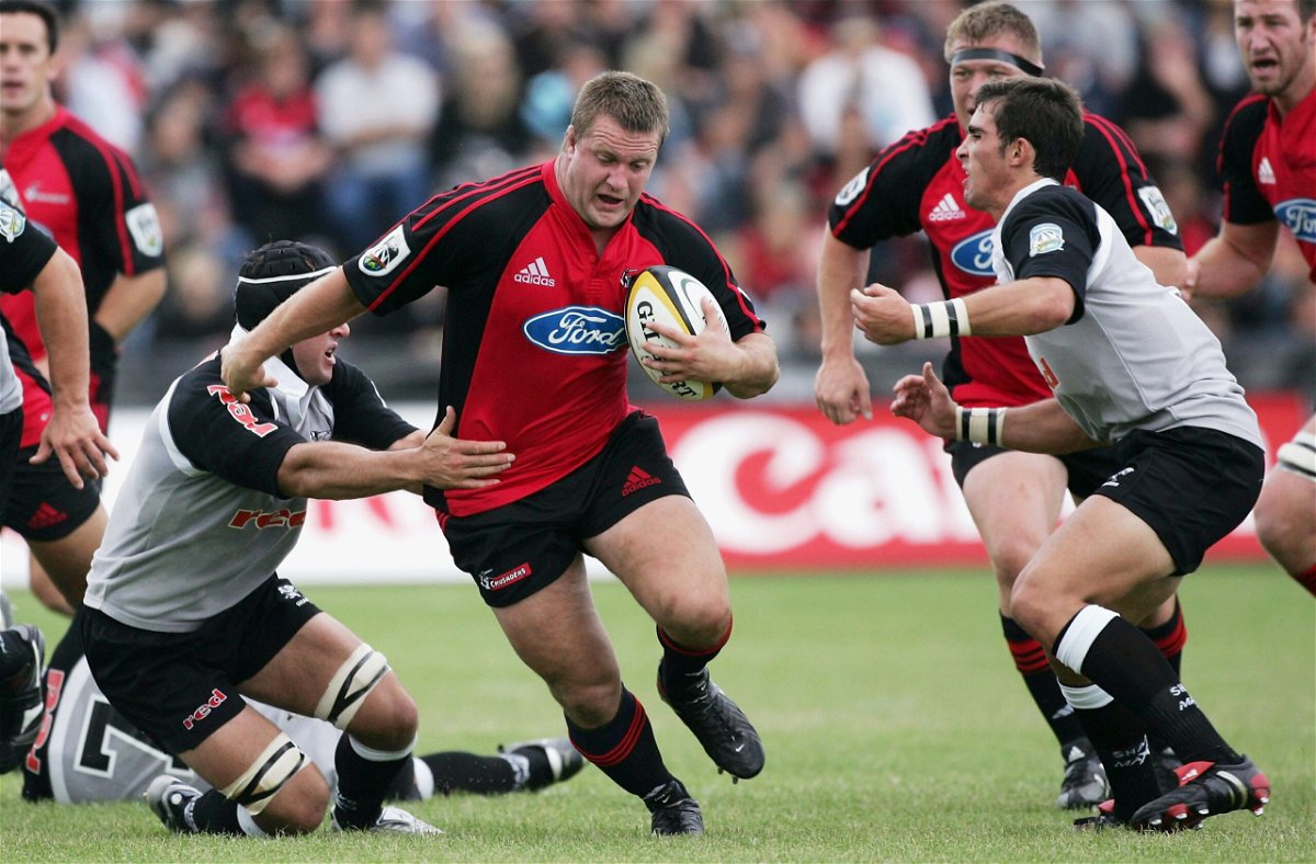 <i>Ross Land/Getty Images</i><br/>Campbell Johnstone (center) looks to evade a tackle during a match between the Crusaders and the Sharks in February 2006.