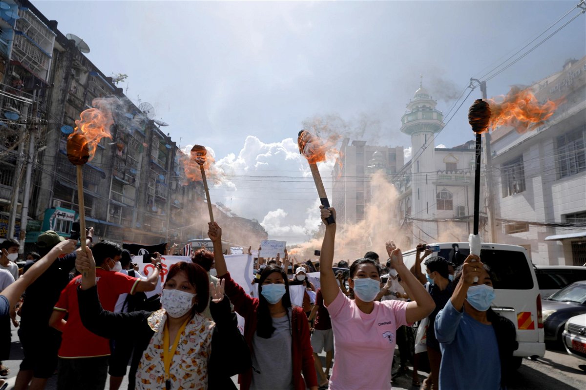 <i>Stringer/Reuters/FILE</i><br/>A group of women hold torches as they protest against the military coup in Yangon