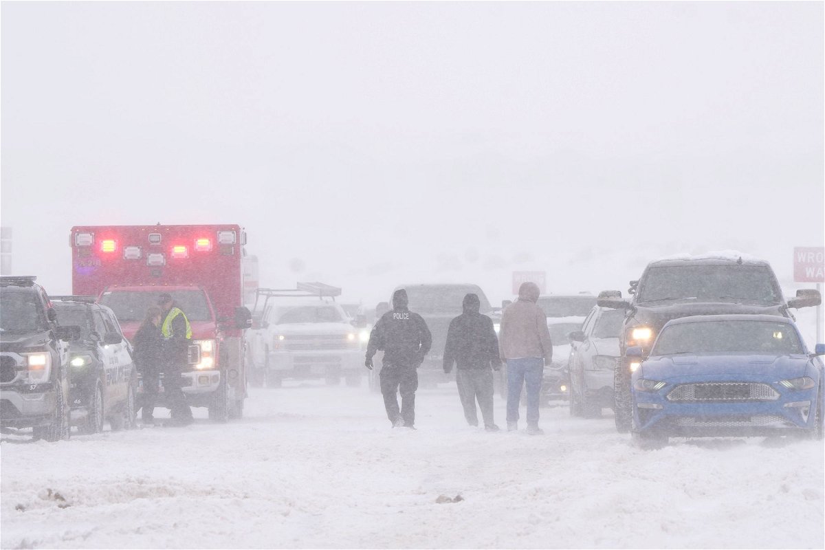 <i>George Frey/AFP/Getty Images</i><br/>Police and emergency workers try to free vehicles from the snow on Mountain View Parkway in Lehi