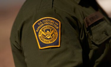 A US Customs and Border Protection patch is seen on the arm of an agent on October 6