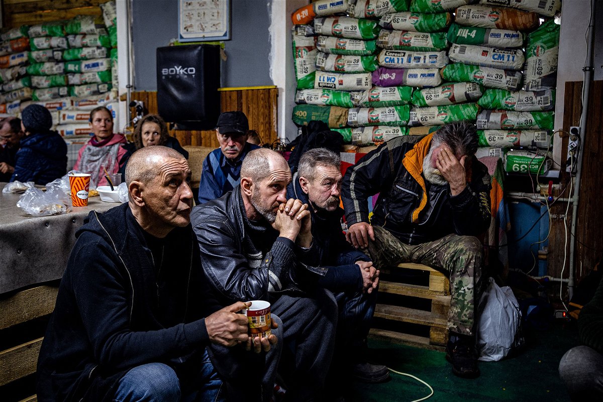<i>Dimitar Dilkoff/AFP/Getty Images</i><br/>Ukrainians watch a movie on TV at a humanitarian aid centre in Bakhmut on Monday