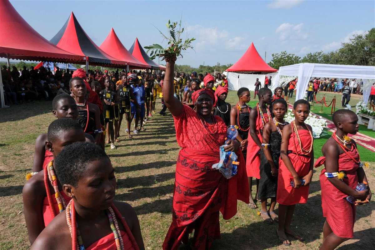 <i>Francis Kokoroko/Reuters</i><br/>Locals perform traditional rites as Atsu is laid in his tomb in Ada.