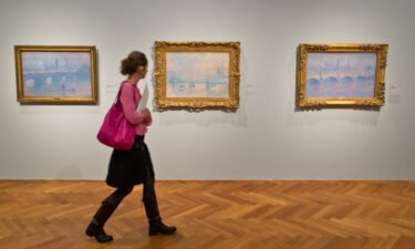 A woman walks through a Claude Monet exhibition at the Stadel Museum in Frankfurt